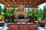 Under the pergola awaits a cozy outdoor living space at this Colorado home