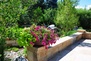 This stone wall by Designscapes borders the outdoor living space